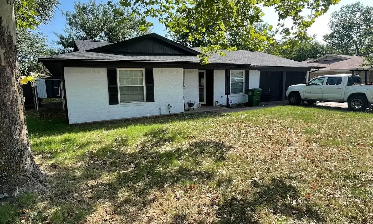 Professional roofing crew working on a residential roof in Laurel